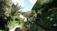 Toscana Immobiliare - garden paths in Cortona, valdichiana with swimming pool and church