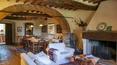 Toscana Immobiliare - Living-dinner room with fireplace of the luxury villa in Arezzo