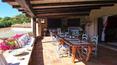Toscana Immobiliare - terrace of the elegant villa in sardinia surrounded by a luxuriant garden with swimming pool