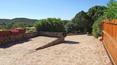 Toscana Immobiliare - Terrace of the elegant villa in sardinia surrounded by a luxuriant garden with swimming pool