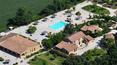 Toscana Immobiliare - The property consists of four stone faceted buildings of a total of 1600 sqm with spacious relax area, pool, gardens, pine forests, groves and orchards.