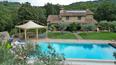 Toscana Immobiliare - The exterior is enhanced by a splendid infinity pool with stone solarium and views of the hills