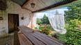 Toscana Immobiliare - The brick facade of the farmhouse blends perfectly with the surrounding vegetation
